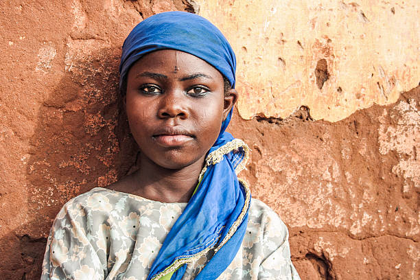 African girl portrait. African girl from looking at camera in front of old wall. benin stock pictures, royalty-free photos & images