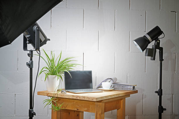 istock Small table top photo studio in a garage with a wooden board for the objects, lights and stands, concept for creative business and hobby at home, copy space 1562366702