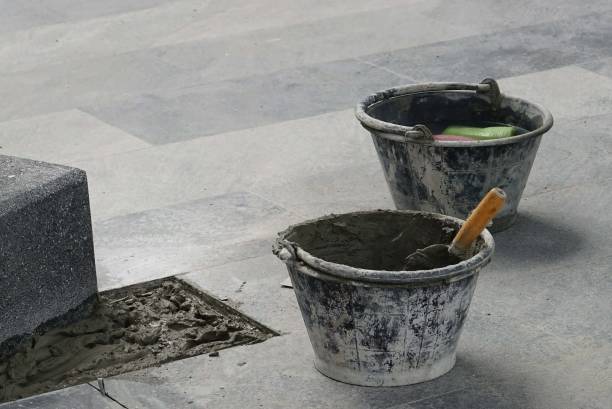 istock A construction trowel and cement bucket on the floor to preparing work. 1562386968