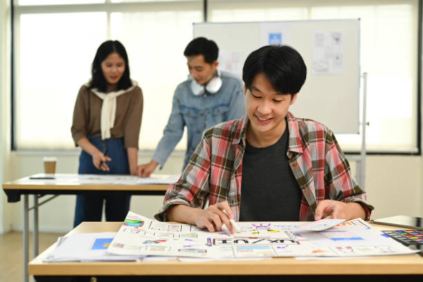 istock Smiling young creative man discussing new app features with her colleagues during meeting at office. 1562398202