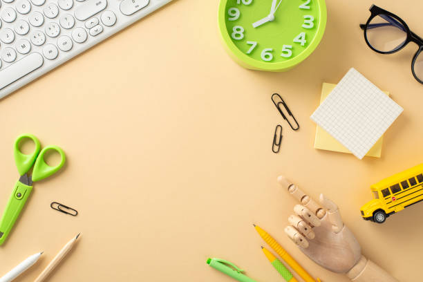 istock Immerse yourself in the digital learning era with this top-view composition, featuring a keypad, toys and stationary on isolated beige backdrop. The empty space is perfect for text or advertising 1562398754