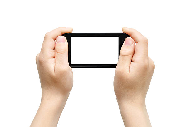 Kid hands holding smartphone with blank white screen  stock photo