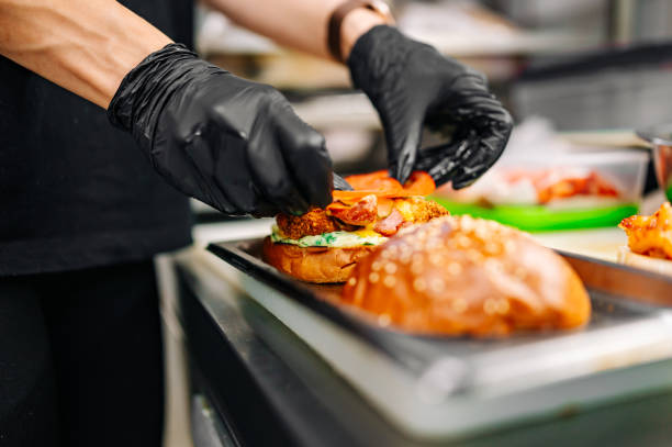 istock chef hand cooking cheeseburger with vegetables and meat on restaurant kitchen 1562423293
