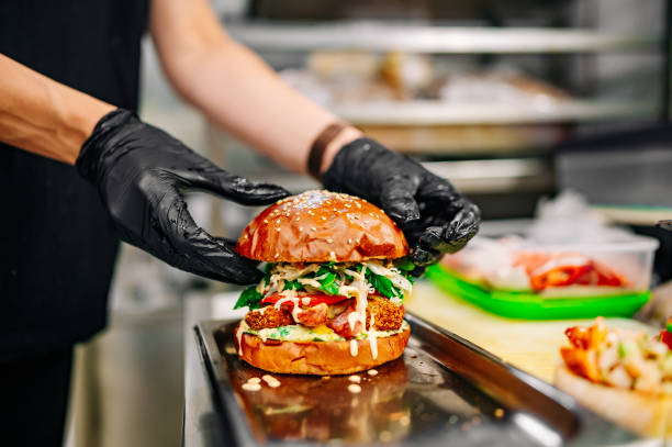 istock chef hand cooking cheeseburger with vegetables and meat on restaurant kitchen 1562423304