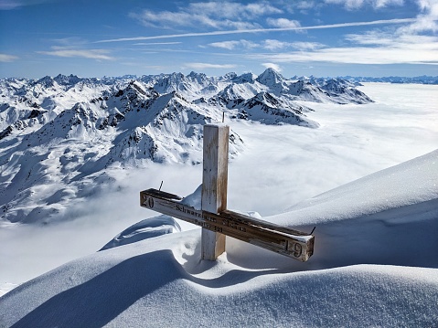 Schwarzhorn above Davos Graubünden. Ski tour from the Fluele Pass. Summit cross in the swiss alps. High quality photo