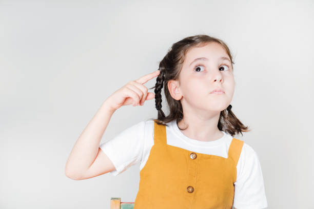istock Thoughtful little girl looking away thinking 1562441734