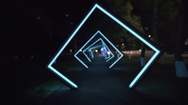 Street lighting at night in a dark alley in the form of luminous squares