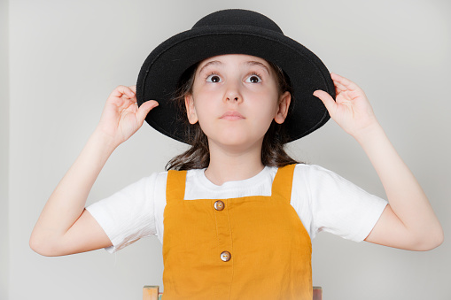 Little girl wearing hat on white background