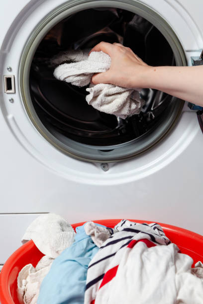 istock Hands take out the washed clothes from the washing machine 1562456064