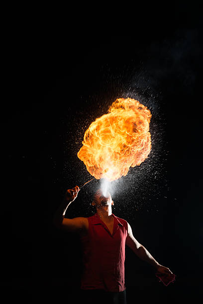 istock Street Performer Fire Breather Blowing on Torch 156246554