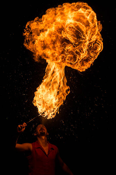 istock Street Performer Fire Breather Blowing on Torch 156246565