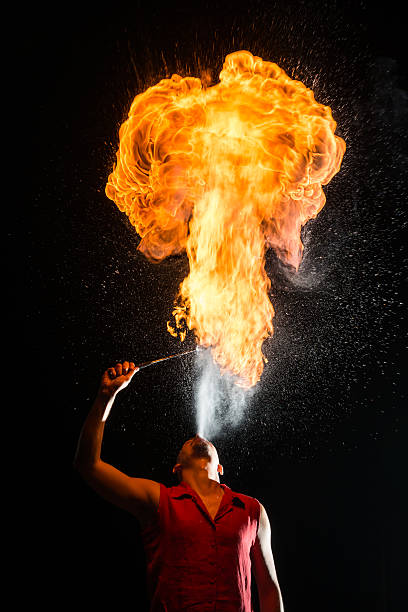 Street Performer Fire Breather Blowing on Torch stock photo
