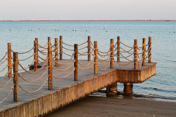 istock Long wooden pier into the sea 1562467812