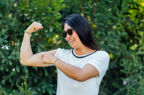 istock Power woman pointing at arm muscles 1562480067