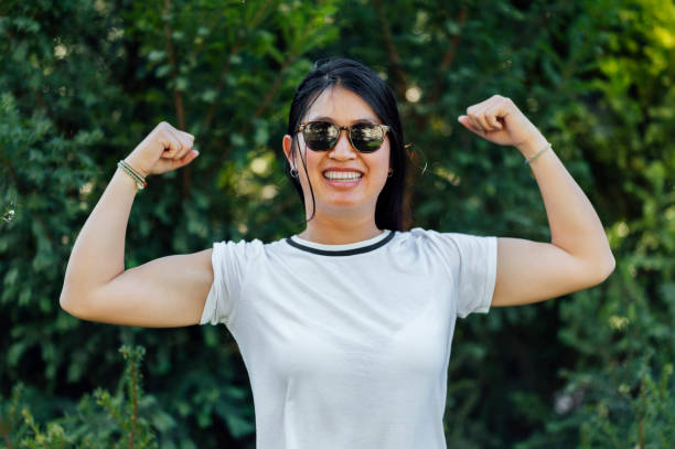 istock Smiling woman showing her strength 1562480397