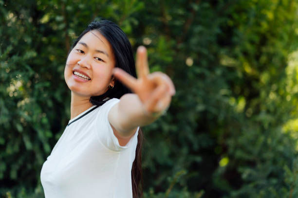 istock Young woman making a V sign 1562480598