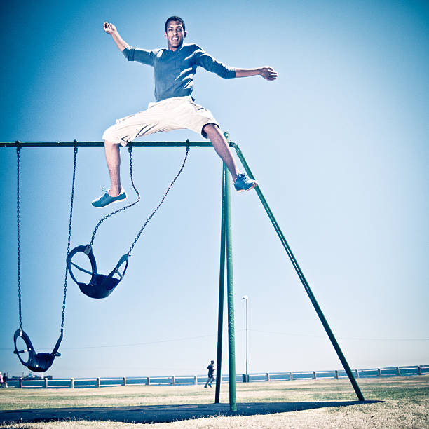 Free Running Parkour Cape Town Free Runner performing a big aerial stunt in Cape Town Sea Point park swings. South Africa. parkour sequence stock pictures, royalty-free photos & images
