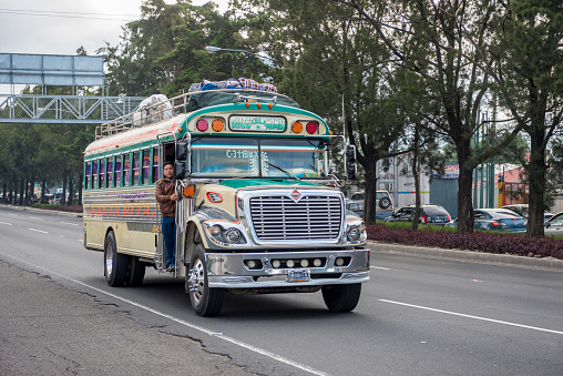 Guatemala - November 11, 2017: Guatemala City Street with Traffic. Daily View of Public Transport, like Colourful Chicken Bus, Taxi.