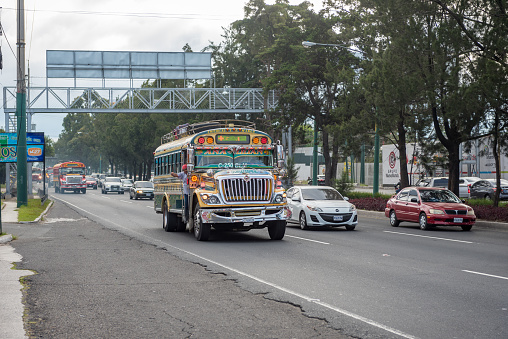Guatemala - November 11, 2017: Guatemala City Street with Traffic. Daily View of Public Transport, like Colorful Chicken Bus, Taxi.