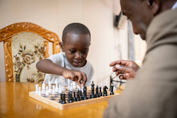 istock Precocious Black boy playing chess with grandfather 1562521052