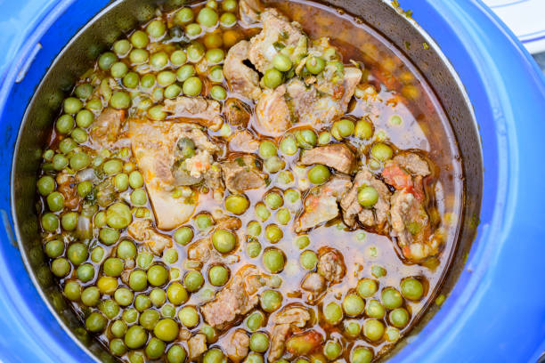 Close-up directly above pan filled with meat, vegetables, and spices.