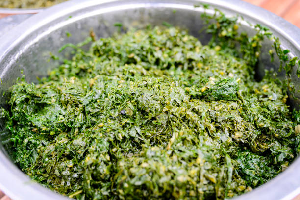 Close-up of collard greens cooked with onions and spices and often served with ugali, a staple starch.
