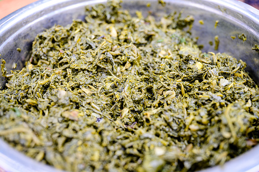 Close view of traditional leafy green vegetable side dish, often served with ugali.