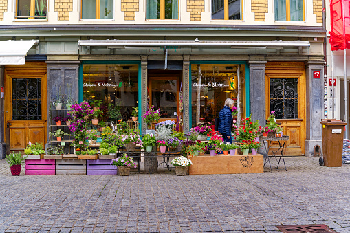 Colorful flowers in front of flower shop at the old town of Swiss City of Winterthur on a cloudy spring day. Photo taken May 17th, 2023, Winterthur, Switzerland.