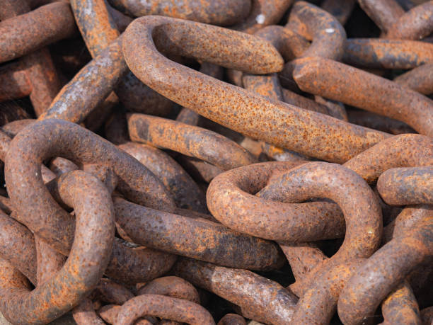 istock Close up rusted links of a thick iron chain 1562551637