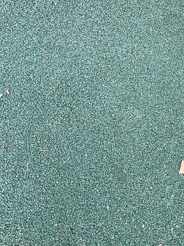 Green all-weather synthetic track surfacing made of polyurethane used for track and field competitions