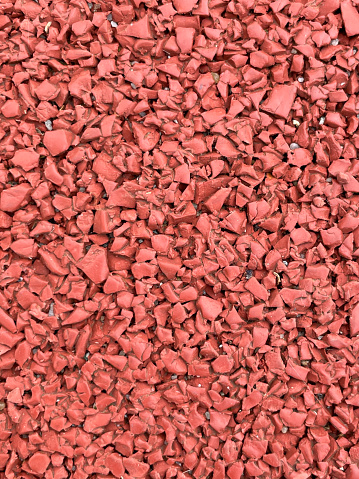 Red all-weather synthetic track surfacing made of polyurethane used for track and field competitions