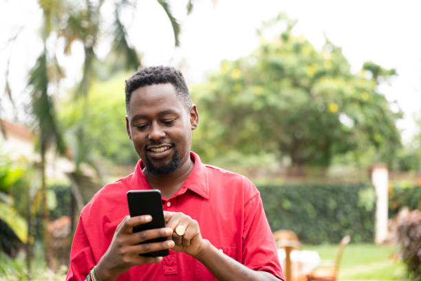 istock African man outdoors in garden and using smart phone 1562573528