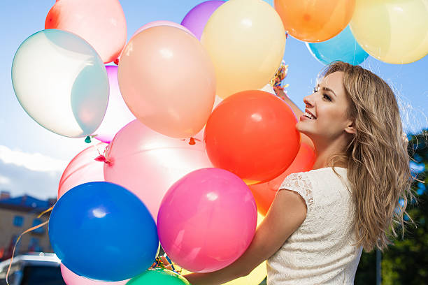 woman with balloons stock photo