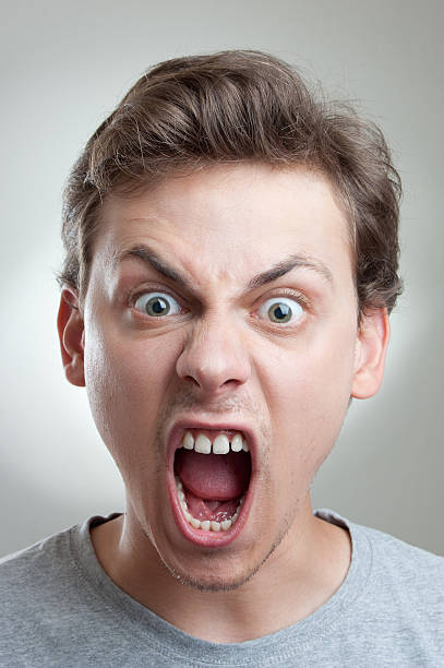 Furioso Retrato de un hombre joven gritando a la cámara - foto de stock
