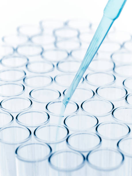 istock Droplet Falling from Pipette into Test Tube. 1562596583