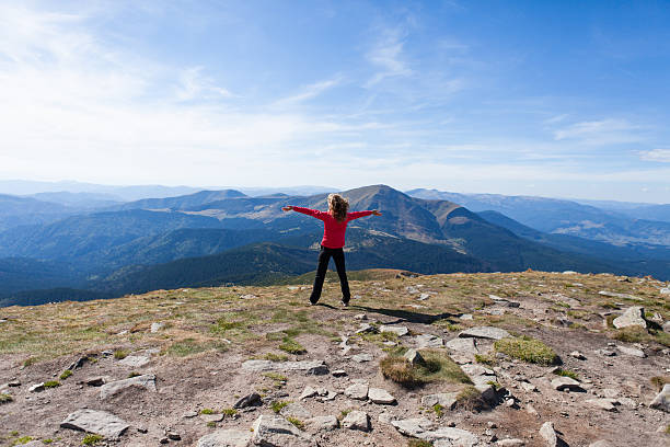 istock Hiker standing on mountain edge and looking to a sky 156260286