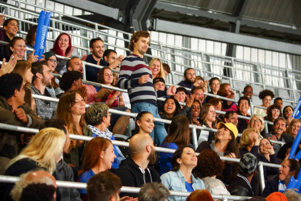 istock Standing man in crowds on stadium 1562610415