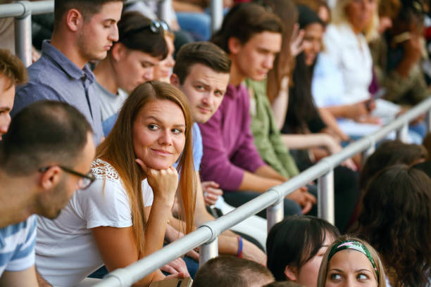 istock Woman sitting on a stadium 1562611486