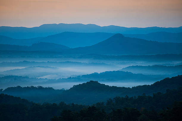 Blue Morning The mountains on the Blue Ridge Parkway welcome the morning with light and mist. Fog is forming in the valley as the sun comes up lighting up the day. blue ridge parkway photos stock pictures, royalty-free photos & images