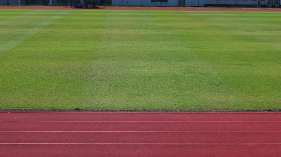 running track at the edge of a football field