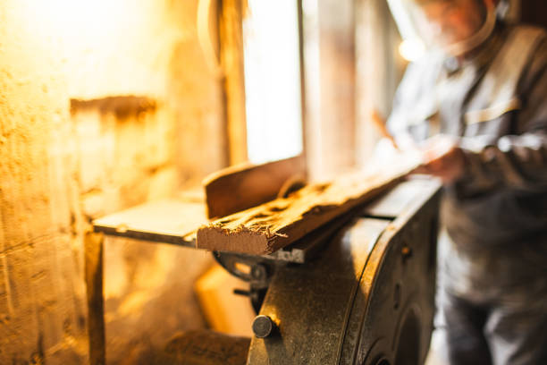 istock Carpenter using a circular saw in the workshop - Stock Photo 1562643902