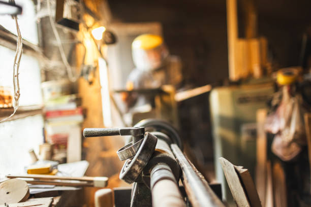Carpenter using a circular saw in the workshop - Stock Photo
