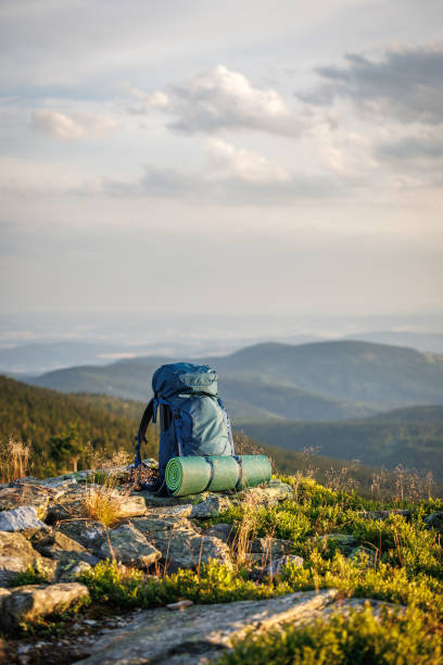 istock Hiking backpack with sleeping pad on rock during trek in mountain 1562650392