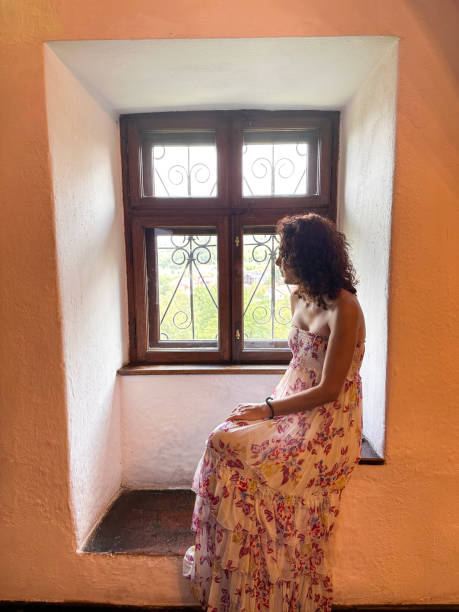 istock Woman looking out of window 1562658938