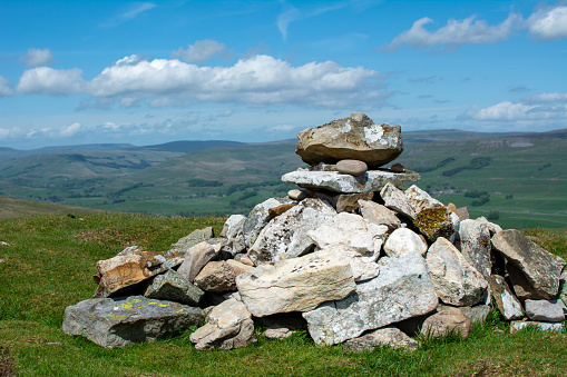 Assorted pile of rocks and stones forming a cairn way marker on a Yorkshire dale summit.