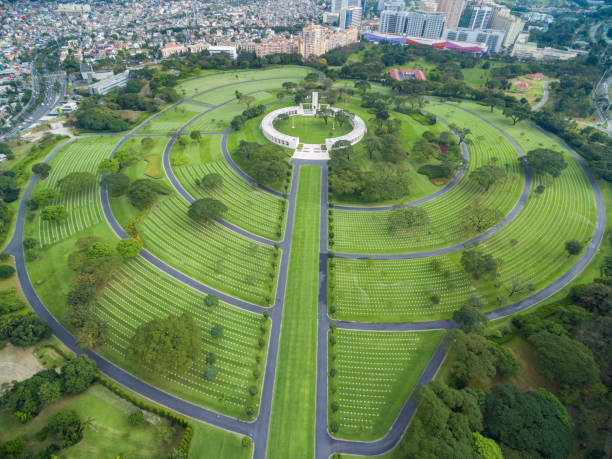 Manila American Cemetery and Memorial. Located in Fort Bonifacio, Taguig City, Metro Manila. Philippines. Taguig, Philippines - February 3, 2018: Manila American Cemetery and Memorial. Located in Fort Bonifacio, Taguig City, Metro Manila. Philippines. Drone Point of View taguig stock pictures, royalty-free photos & images