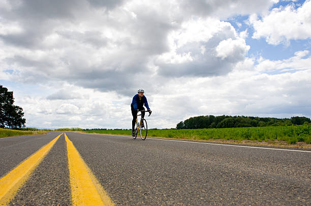 istock Cyclist on a Country Road 156269254