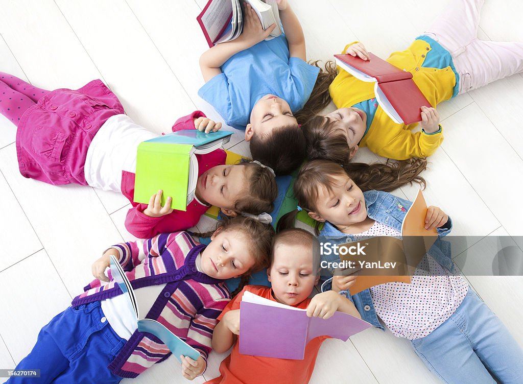 Children are reading Group of children enjoying reading together Reading Stock Photo