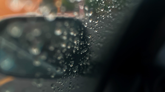 Raindrops in the rainy season clinging to the windshield in large numbers.