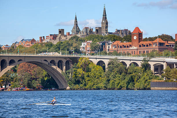 Key Bridge Georgetown University Washington DC Potomac River Rowing Potomac River Key Bridge Georgetown University Washington DC from Roosevelt Island.  Completed in 1923 this is the oldest bridge in Washington DC. potomac river photos stock pictures, royalty-free photos & images